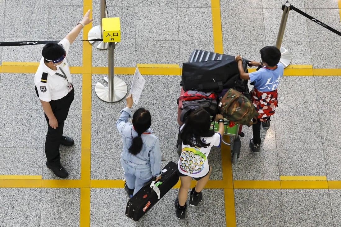 Passengers arrive at Hong Kong’s airport before being taken to quarantine hotels. Photo: K. Y. Cheng