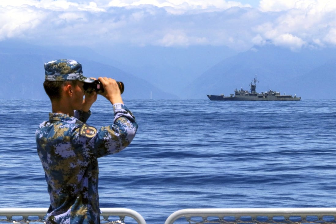 A soldier looks through binoculars during PLA Navy combat exercises and training in the waters around Taiwan on Friday. Photo: Xinhua