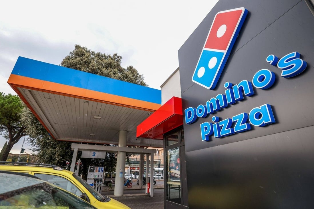 A closed-down Domino’s Pizza store is seen near a fuel station in Rome, Italy on Tuesday. Photo: Bloomberg
