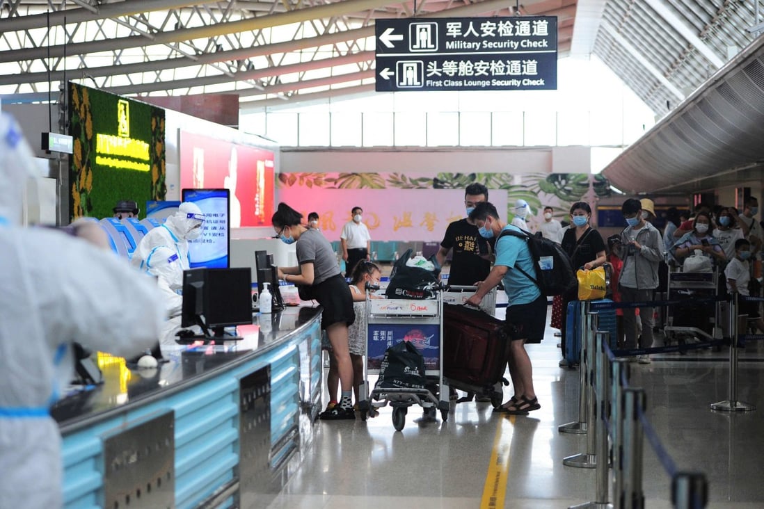 Tourists prepare to depart from Sanya Phoenix International Airport in Hainan province on Tuesday. Tens of thousands of tourists were stranded in the island province due to Covid-related travel restrictions. Photo: AFP
