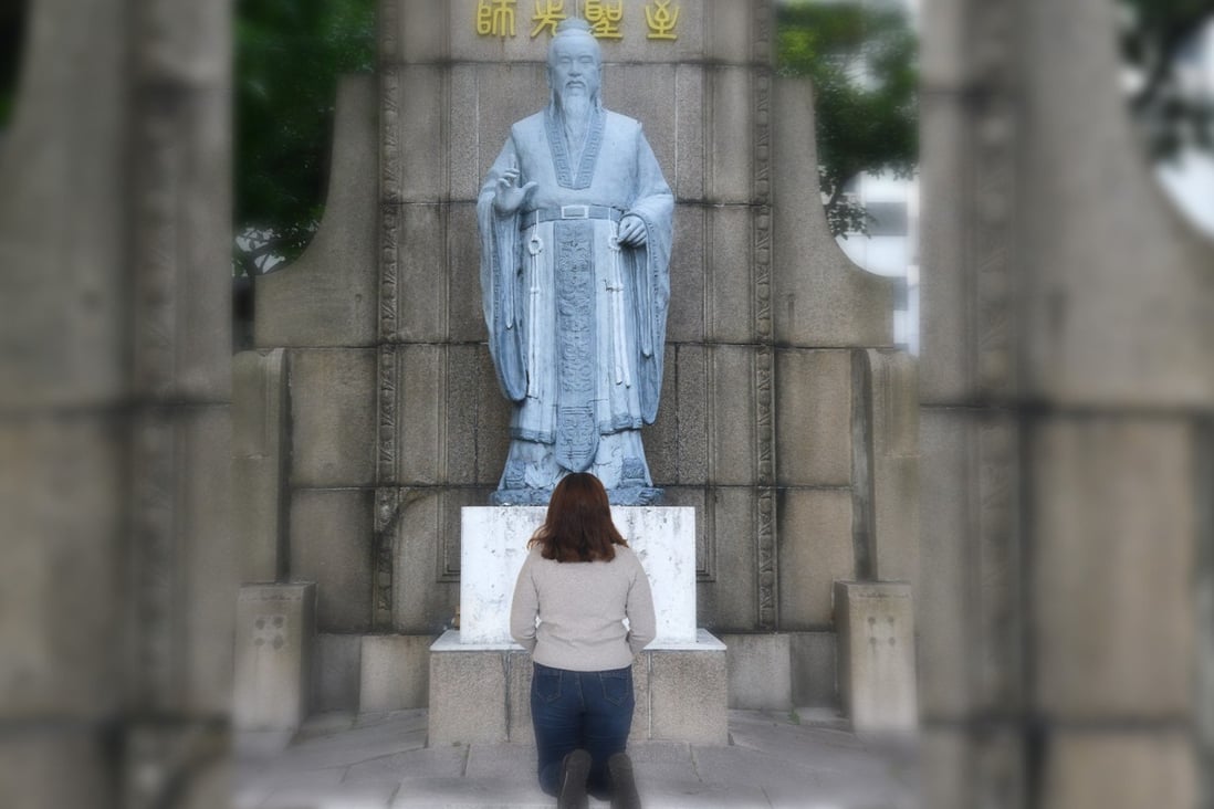 A Chinese girl kneels before a Confucius statue begging forgiveness for a low test score in a video that has gone viral in China. Photo: Handout 