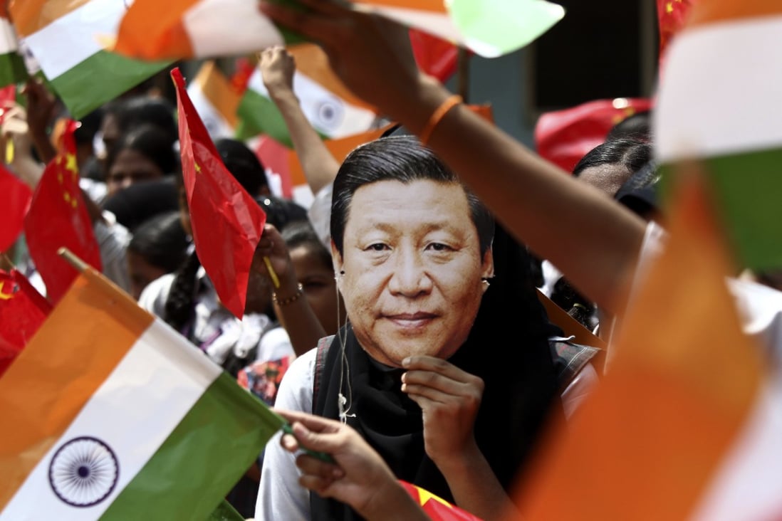 An Indian schoolgirl in Chennai wears a Xi Jinping face mask at a rally to welcome the Chinese president to India during a state visit in 2019. Photo: AP