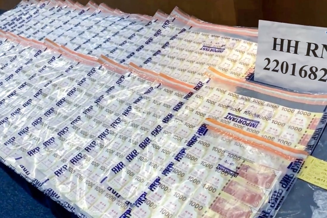 Hong Kong police display the fake notes a businessman was given after transferring about HK$1.58 million (US$200,000) in digital money in a bogus cryptocurrency transaction. Photo: Hong Kong Police