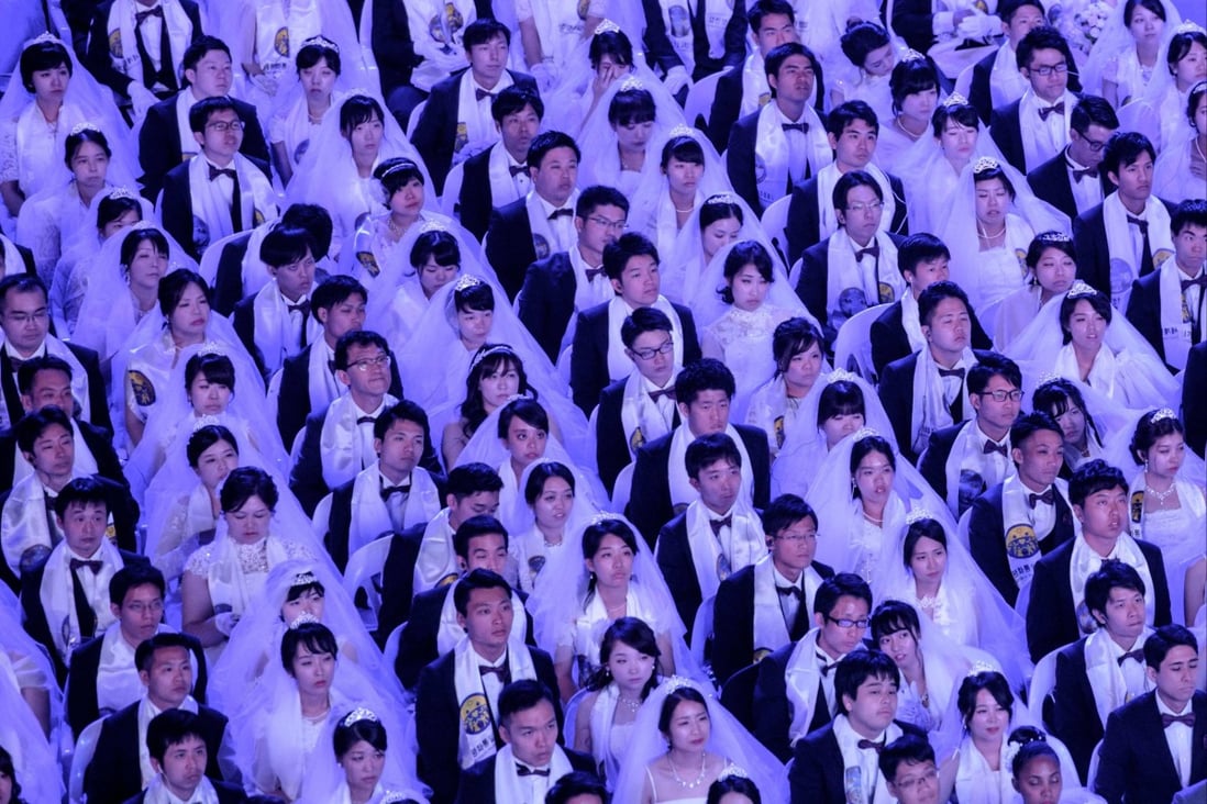 Couples attend a mass wedding ceremony in South Korea organised by the Unification Church. Japan has set up a panel to investigate “spiritual sales” by the church. Photo: AFP