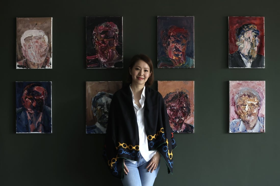 Artist Sharon Cheung with some of her distorted portraits from the “Our Time” exhibition at her SC Gallery in Wong Chuk Hang, Hong Kong. Photo: Jonathan Wong