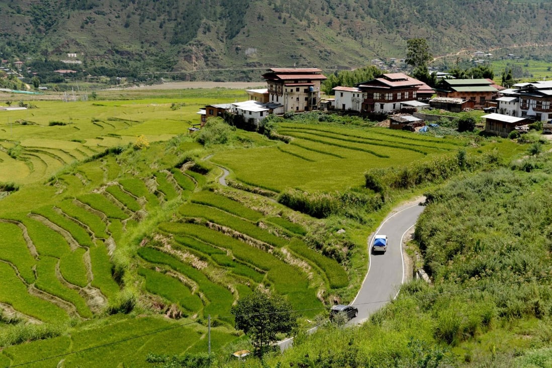 Vehicles are seen driving along a road in a valley near Punakha, Bhutan. The country of fewer than 800,000 people has banned most vehicle imports to preserve its dwindling foreign exchange reserves. Photo: AFP