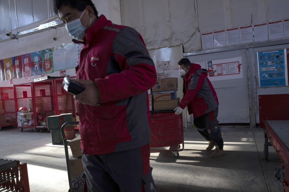 In this Feb. 18, 2020 photo, delivery workers for JD.com prepare for the morning round of deliveries from a distribution center in Beijing. Photo: AP
