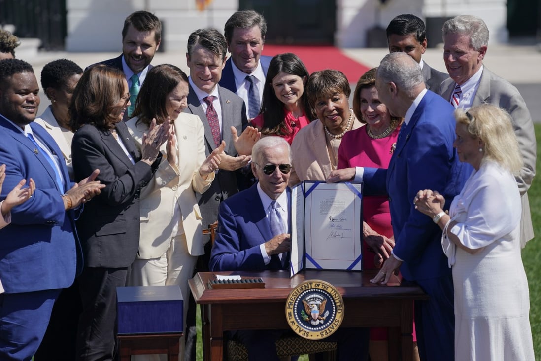 US President Joe Biden with the Chips and Science Act after signing it on the South Lawn of the White House on August 9. Photo: AP