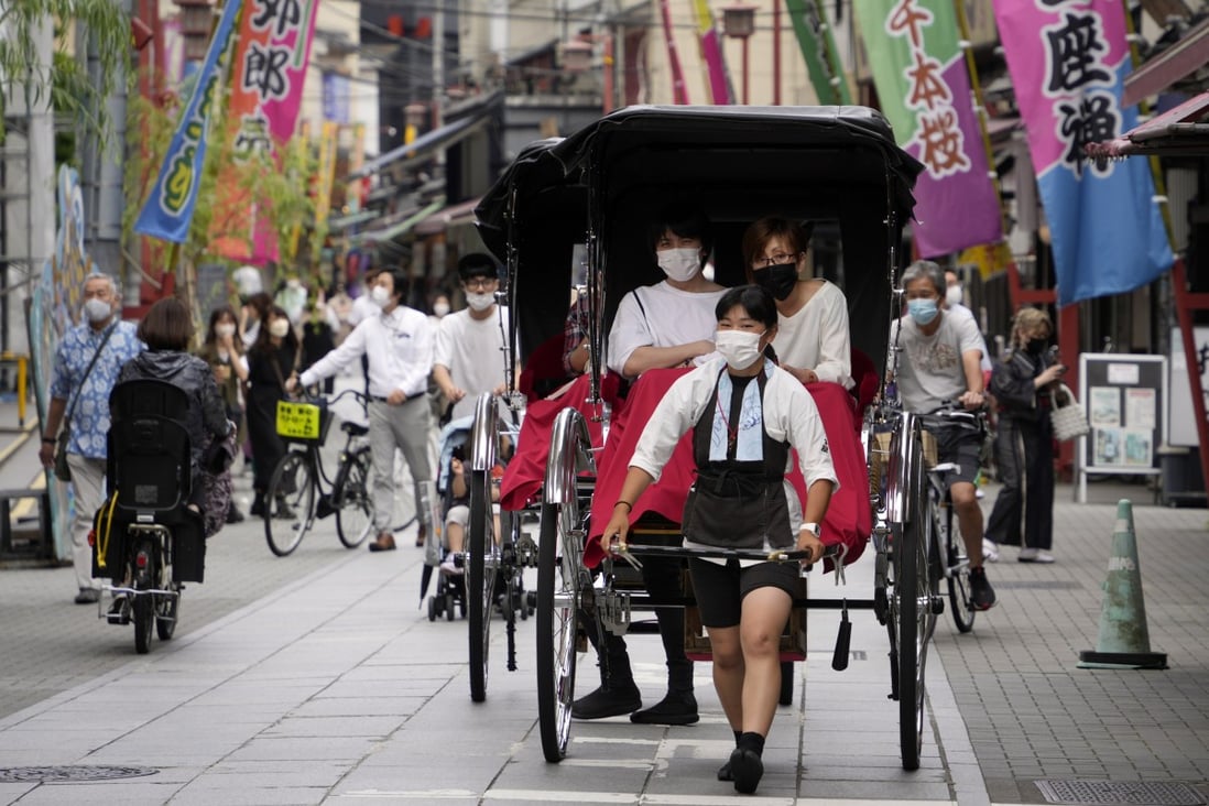 Tourists enjoy a rickshaw ride in Asakusa district in Tokyo in June. Japan’s tourism industry has welcomed news that border controls could soon be eased. Photo: EPA-EFE