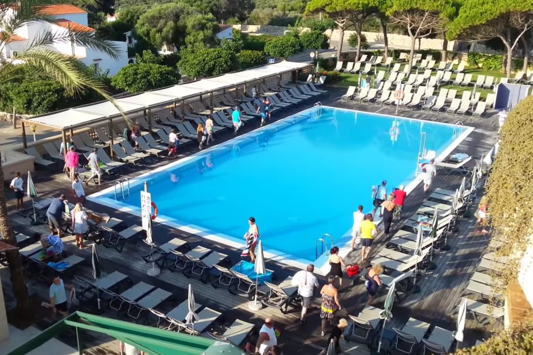 British tourists at the Hotel San Luis Menorca, on one of Spain’s Balearic islands, wait for the pool to open before scrambling to claim their spot in the sun for the day. Photo: YouTube