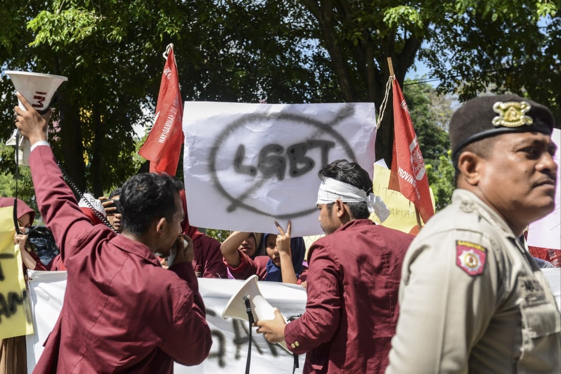 A group of Muslim protesters march with banners against the LGBT community in Banda Aceh, Indonesia in 2017. Photo: AFP