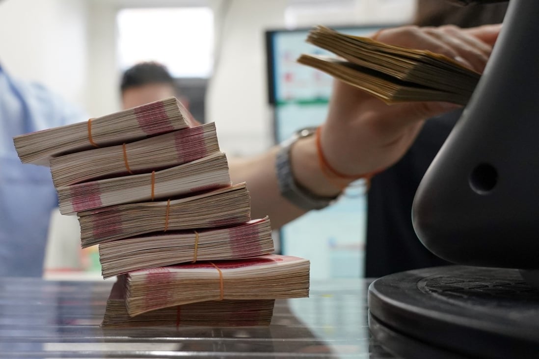 Bundles of Chinese yuan banknotes at a money exchange. Mainland rate cuts are aimed at shoring up business and consumer confidence to a Covid-battered economy. Photo: Bloomberg
