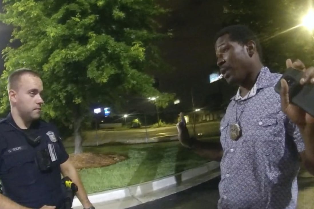 Rayshard Brooks, right,  speaks with Officer Garrett Rolfe, left, in the parking lot of a Wendy’s restaurant in Atlanta, June 12, 2020. A specially appointed prosecutor said on Tuesday he will not pursue any charges against the officer who fatally shot Brooks more than two years ago. Photo: Atlanta Police Department via AP, File