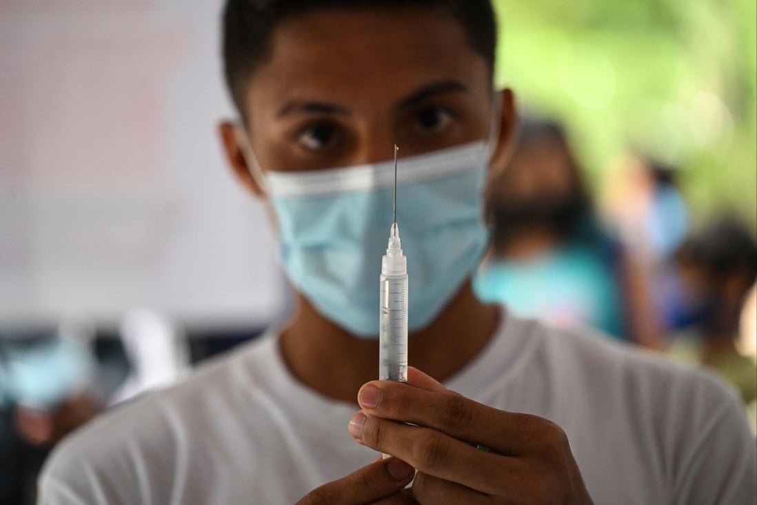 A healthcare worker prepares a syringe to administer a vaccine. File photo: AFP