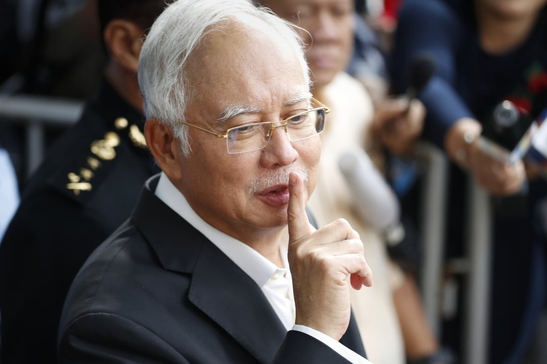 Najib Razak gestures as he leaves the Malaysian Anti-Corruption Commission Office in 2018. Photo: AP