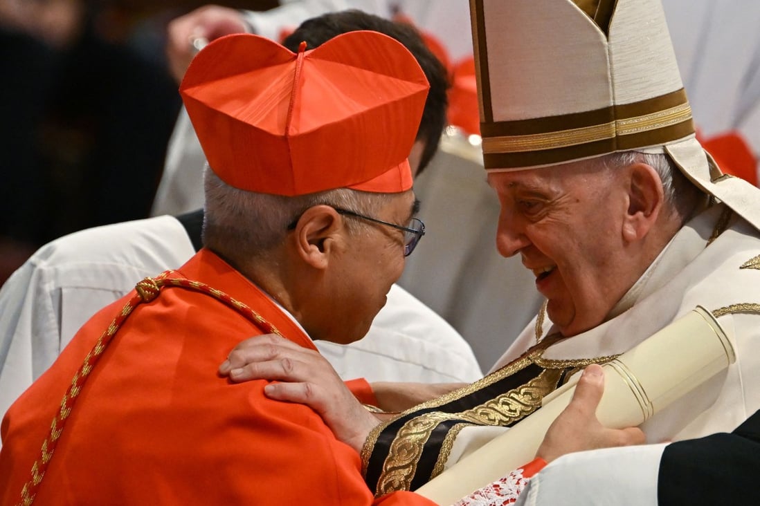 Pope Francis speaks to Monsignor William Seng Chye Goh, left, after he elevated him to Cardinal during a consistory to create 20 new cardinals, on Saturday. Photo: AFP/Getty Images
