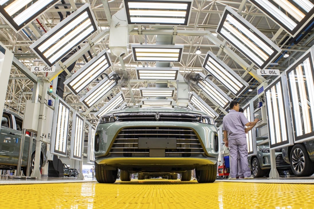 Employees work on the assembly line of electric vehicle maker Seres Automobile in Chongqing, China, on August 9. Photo: Getty Images