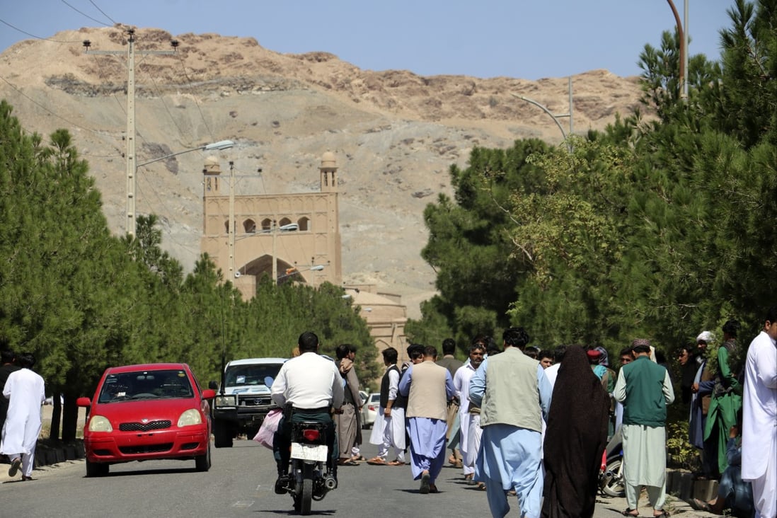 People gather near the site of an explosion at a mosque in Herat province, Afghanistan, on Friday. Photo: AP