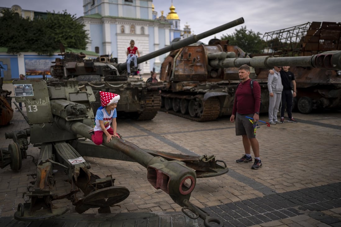 Children play on destroyed Russian military vehicles in central Kyiv, Ukraine on Saturday. Several children were killed and injured as a result of Russian attacks and the negligent handling of ammunition on Saturday. Photo: AP 