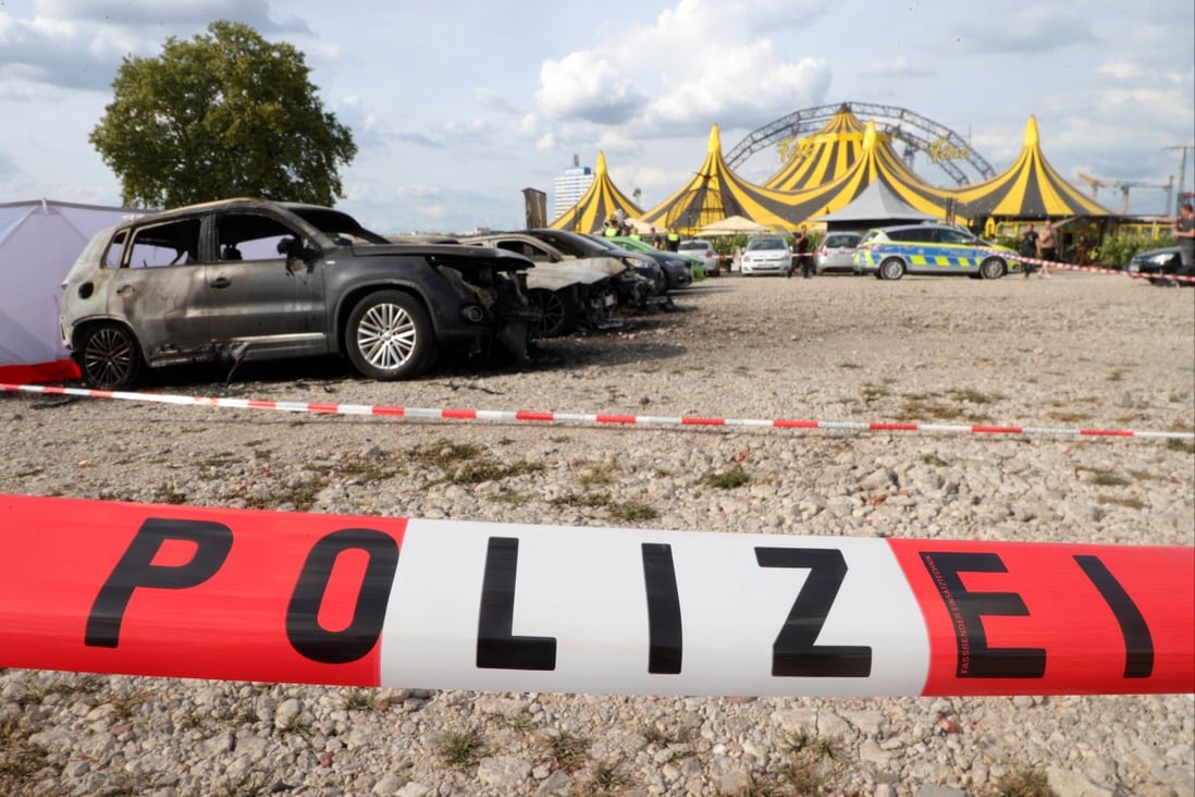 Police inspect the scene around burnt cars after a small plane crashed at the parking lot of FlicFlac circus in Duisburg, Germany on Saturday. Photo: EPA-EFE