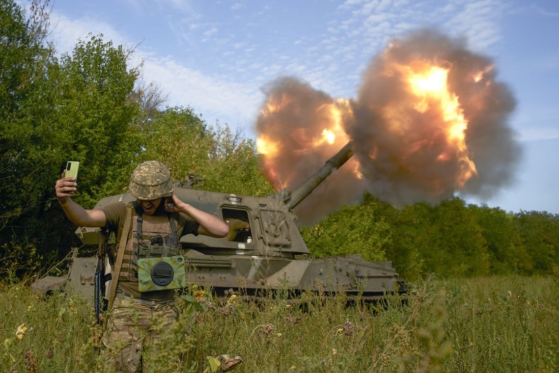 A Ukrainian soldier takes a selfie as an artillery system fires in Donetsk region, eastern Ukraine. Photo: AP