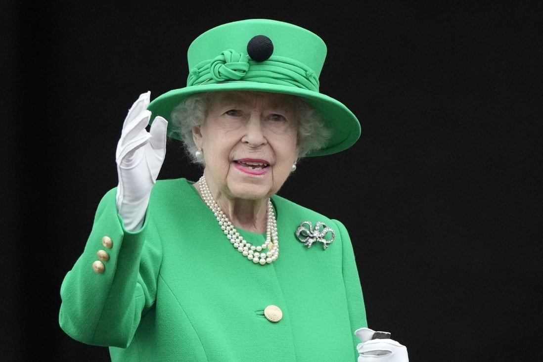 Queen Elizabeth waves to the crowd during the Platinum Jubilee Pageant at Buckingham Palace in June. Photo: AP