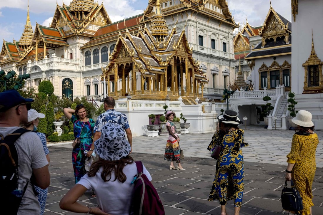 Tourists in the grounds of the Grand Palace in Bangkok on July 18, 2022. Photo: AFP
