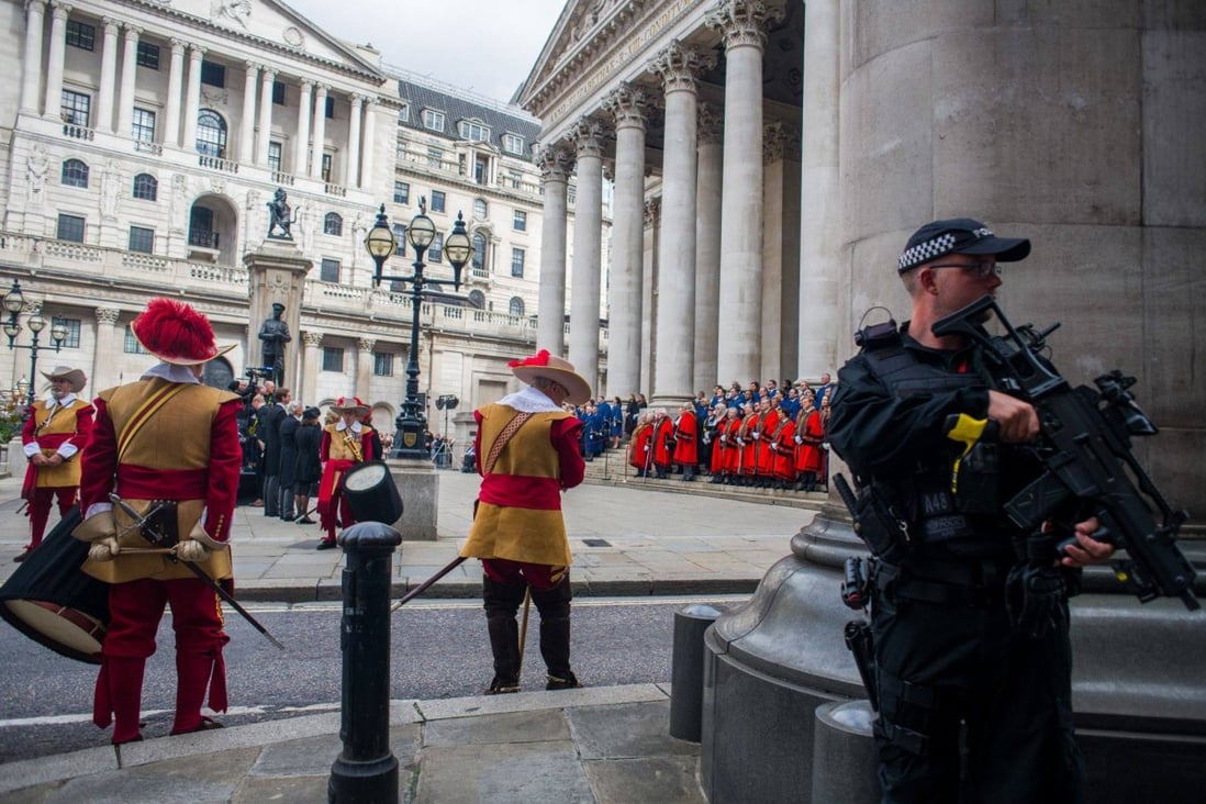 An armed police officer stands guard in London on day two of public mourning following the death of Queen Elizabeth II. Britain’s police are making plans for security at her funeral. Photo: Bloomberg