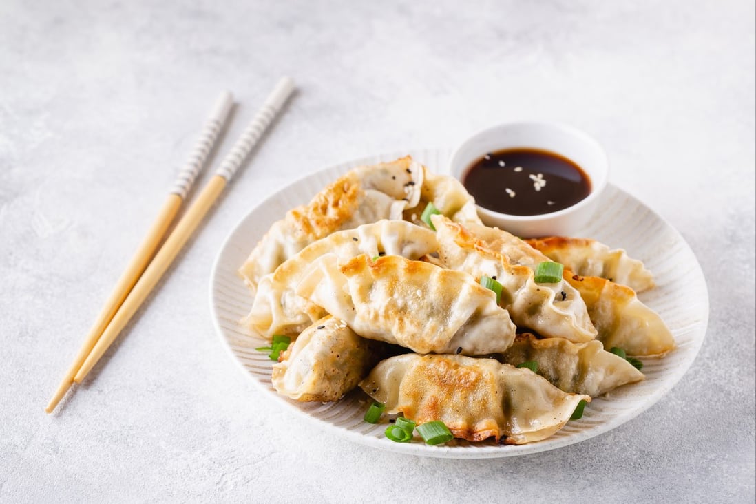 Fried gyoza dumplings with soy sauce. Dumplings feature in many cuisines, but with no agreed-upon history or definition, the only thing that ties them together is that they are made from common ingredients found on hand. Photo: Shutterstock