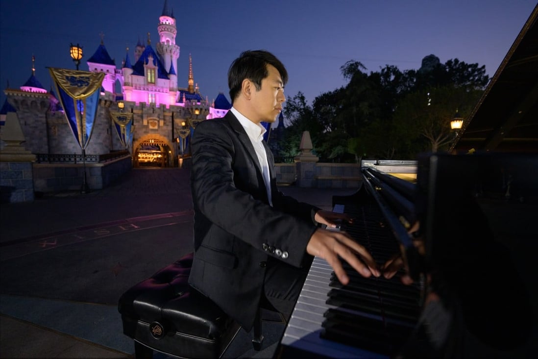 Lang Lang in front of the Sleeping Beauty Castle at the Disneyland Resort, California. He is promoting his new album The Disney Book, a collection of newly arranged theme songs. Photo: Richard Harbaugh