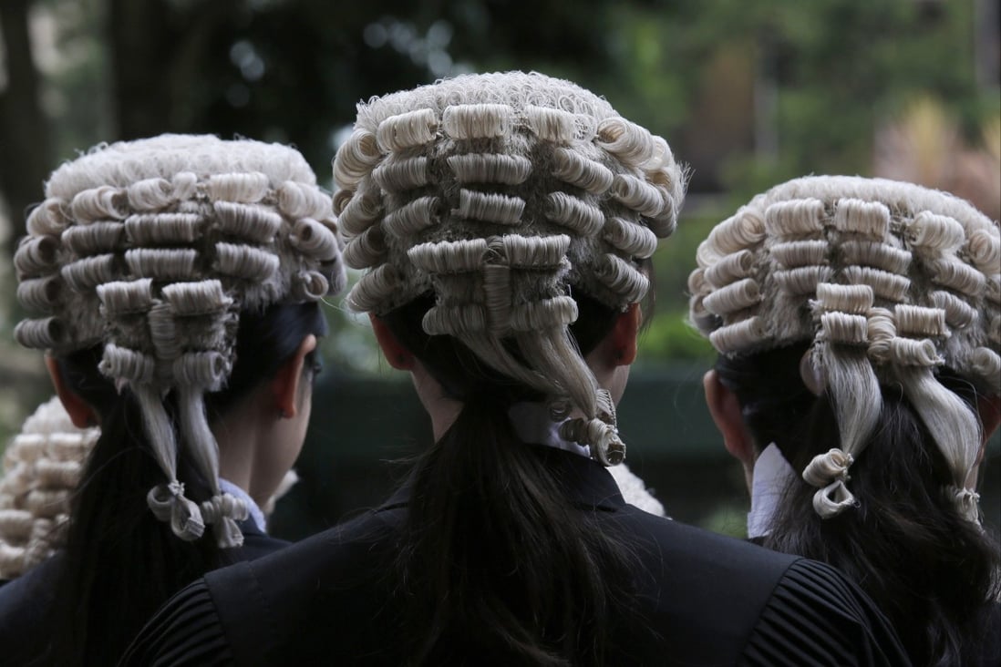 Barristers line up after an appointment ceremony for senior counsel outside the Court of Final Appeal in Hong Kong in June 2019. As a matter of course, the top court hears matters and writes its decisions in English. Photo: AP