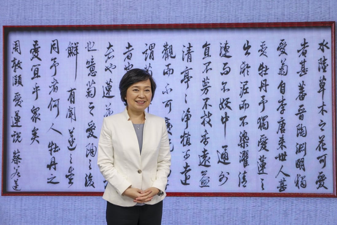 Secretary for Education Christine Choi Yuk-lin poses against a display of her calligraphy (“On the Love of the Lotus” by Zhou Dunyi of the Northern Song Dynasty) at the Education Bureau on July 13. The bureau has been trying to encourage a more efficient Chinese learning environment at school by introducing Mandarin as the teaching language. Photo: Nora Tam