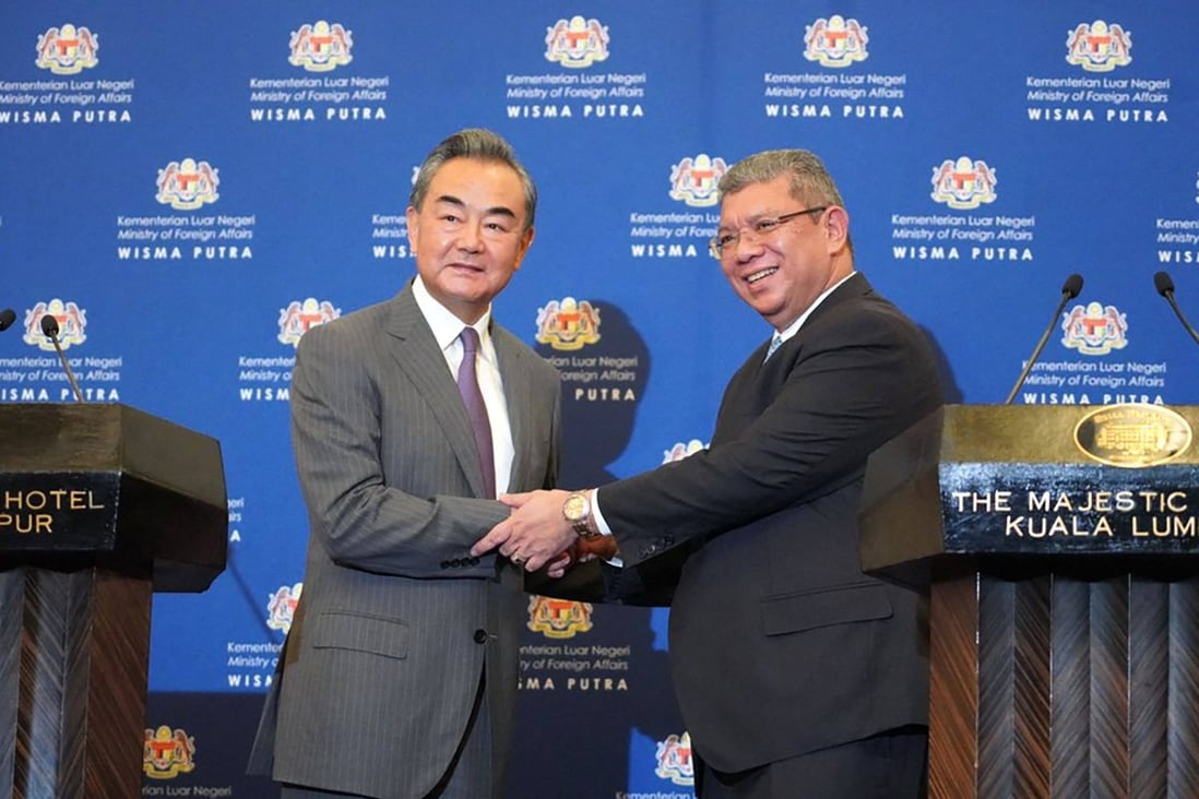 Malaysia’s Foreign Minister Saifuddin Abdullah (right) shakes hands with Chinese Foreign Minister Wang Yi after a joint press conference at the foreign ministry in Putrajaya on July 12. Photo: AFP/Malaysia’s Ministry of Foreign Affairs