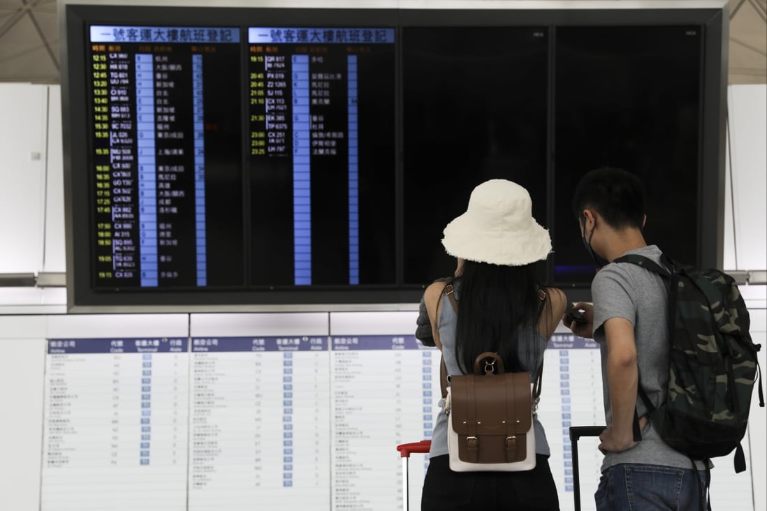 Passengers check the flight schedule in the departure hall at Hong Kong International Airport on September 10. People in their early 20s have emerged as the main group of Hongkongers who have left the city over the past five years. Photo: Yik Yeung-man