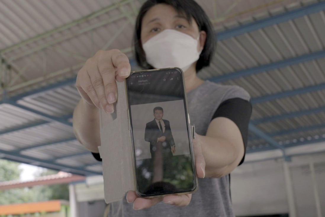Malaysian Yang Fei Pin holds her phone showing a photograph of her late son Goi Zhen Feng. Photo: SCMP / Aidan Jones 