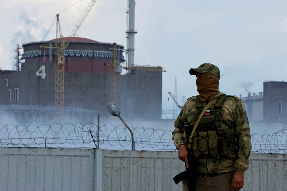 A serviceman with a Russian flag on his uniform stands guard near the Zaporizhzhia Nuclear Power Plant in Ukraine in August. Photo: Reuters