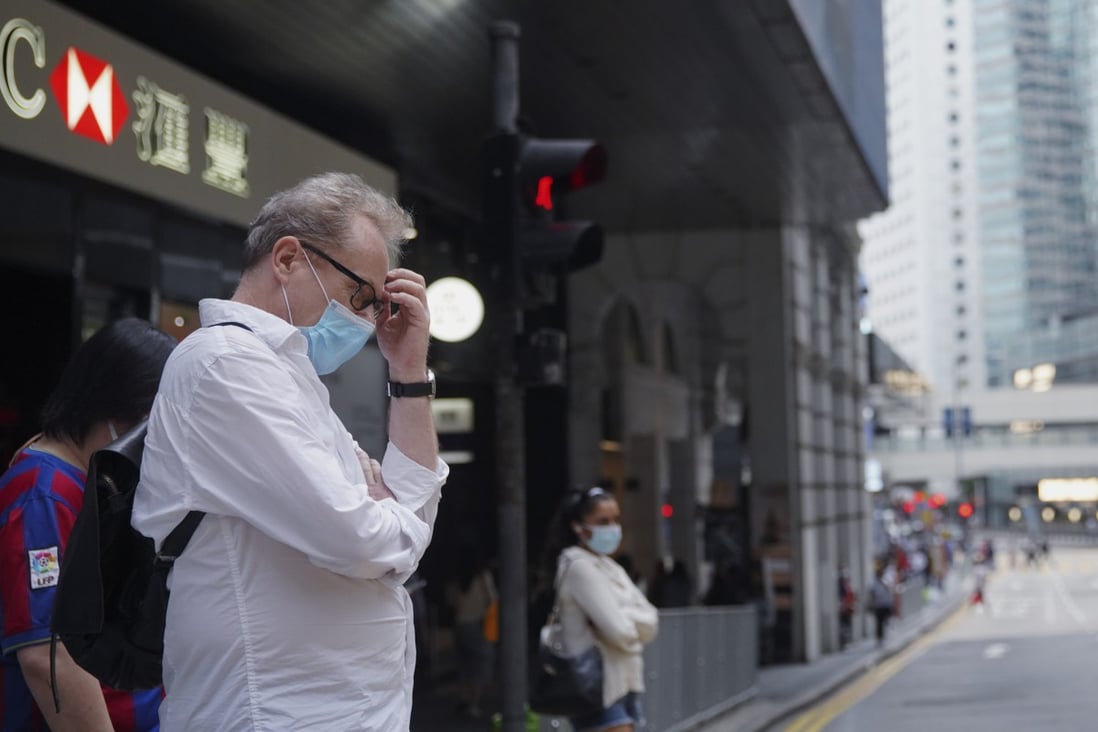 People wait at a traffic light in Central, Hong Kong, amid the pandemic on October 23, 2020. After almost three years of Covid-prevention restrictions in the city, fatigue has set in. Photo: Winson Wong