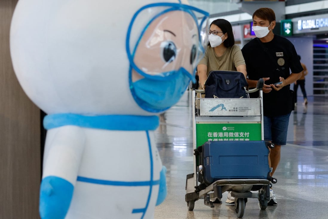 Travellers walk past an installation featuring a medical worker at the Hong Kong International Airport’s departure hall on August 1. Photo:  Reuters
