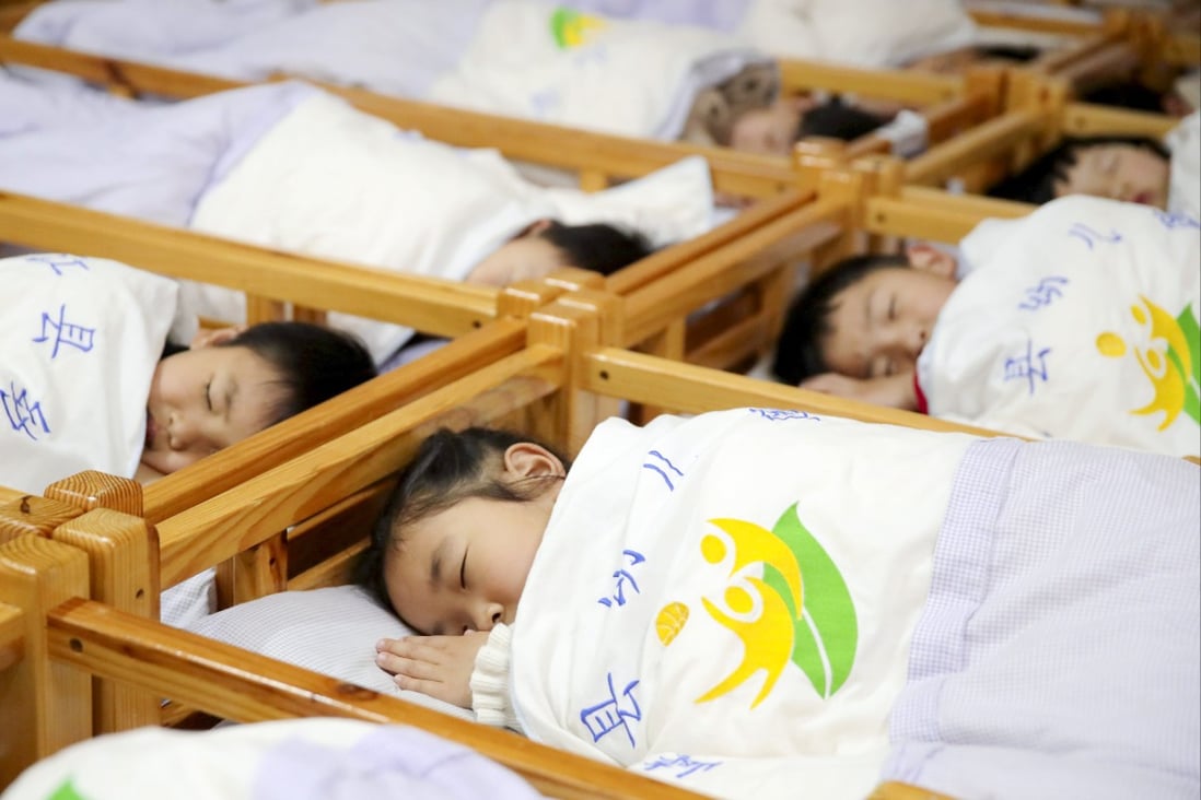 Children learn about proper sleeping position at a kindergarten on World Sleep Day, March 19, 2021, in Ji’an, China’s Jiangxi Province. Photo: VCG via Getty Images
