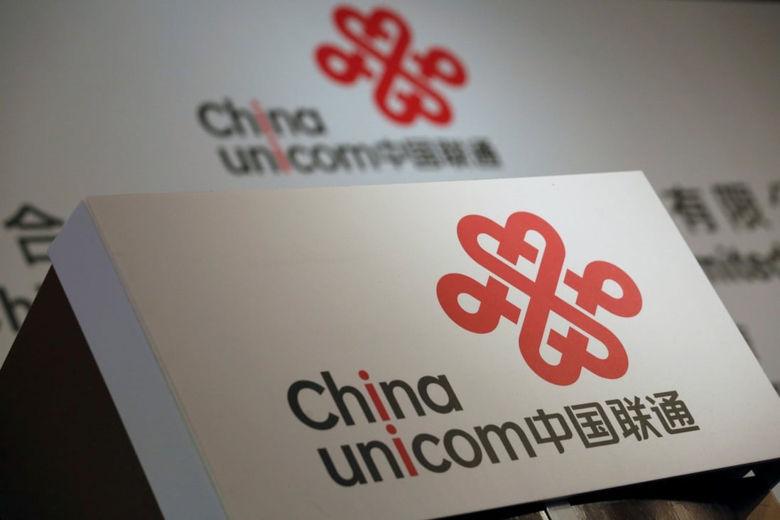China Unicom logos are displayed at a news conference in Hong Kong in March 2016. Phooto: Reuters