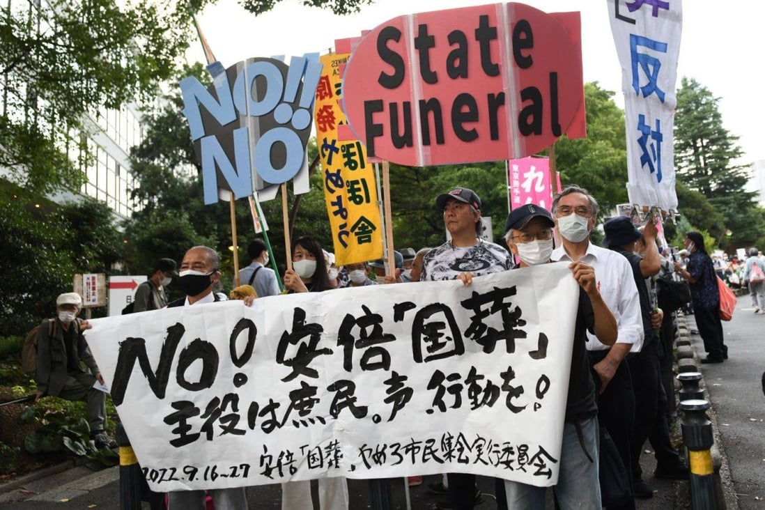Demonstrators hold placards during a protest against the planned state funeral for slain former Japanese prime minister Shinzo Abe in Tokyo last week. Photo: Bloomberg