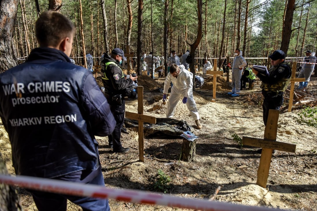 War crime prosecutor personnel are seen during exhumation work on the cemetery in Izium, Ukraine on Thursday. Photo: EPA-EFE