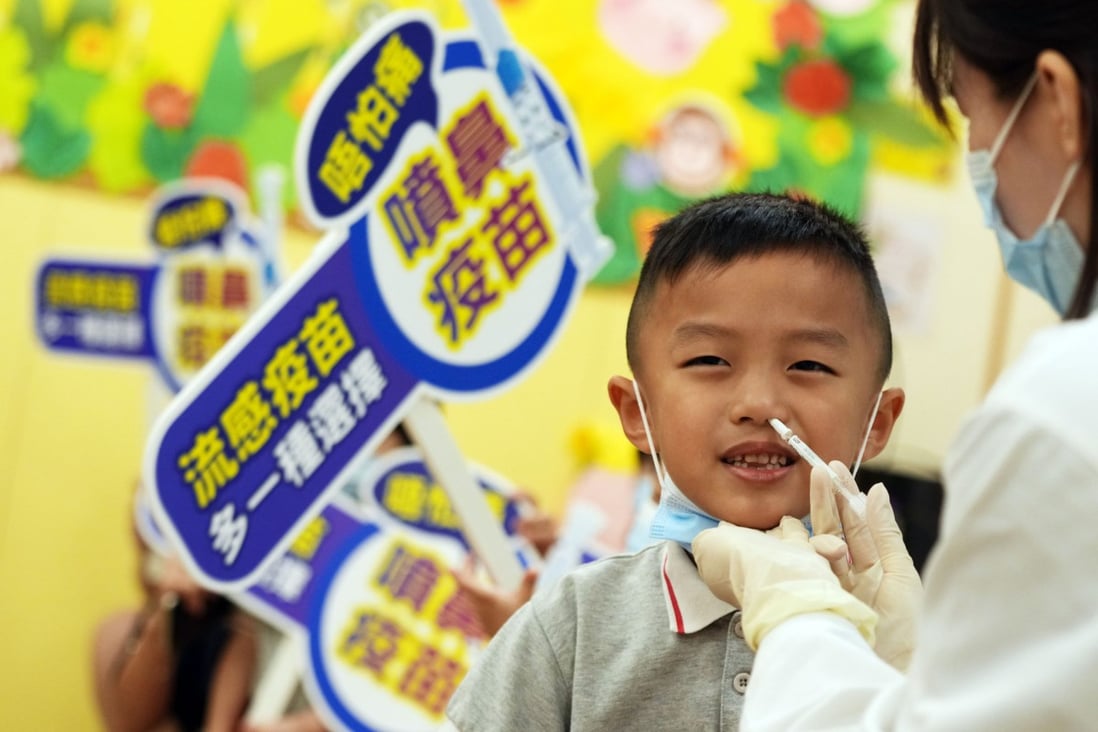 A little boy gets the nasal spray flu vaccine at Five District Business Welfare Association Cheung Chuk Shan Kindergarten on Sunday. Photo: Sam Tsang
