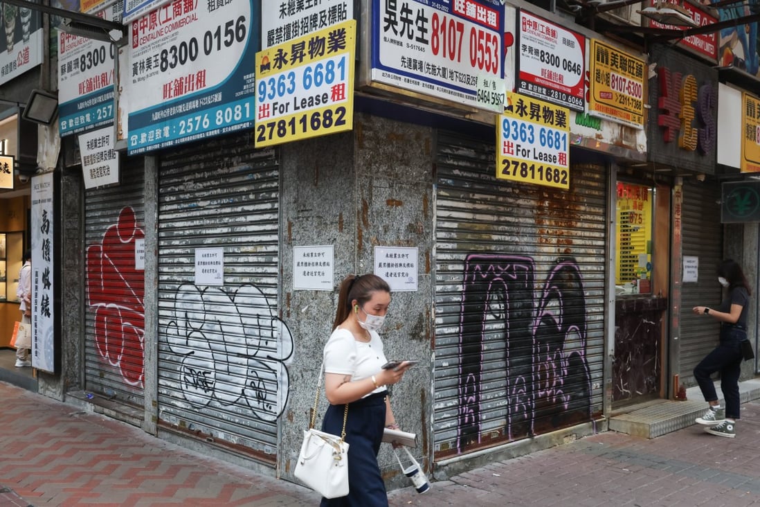 A woman walks past closed retail shops in Mong Kok on September 19. Hong Kong stock and property markets are down, while small and medium-sized enterprises face unprecedented difficulties. Photo: Edmond So