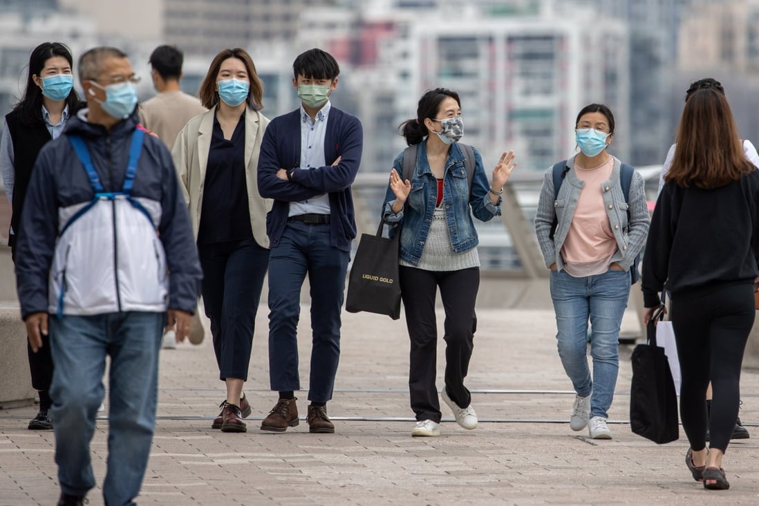 People wear face masks while outdoors in Hong Kong on March 29. The anti-Covid-19 measures have touched so many areas of our lives. Photo: EPA-EFE