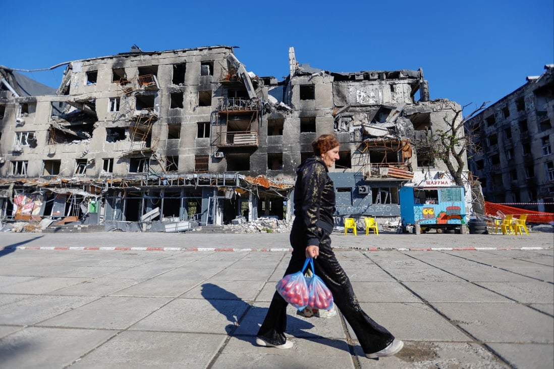 A local resident walks past a block of flats damaged in the course of Russia-Ukraine conflict in Mariupol, Ukraine on Sunday. Photo: Reuters