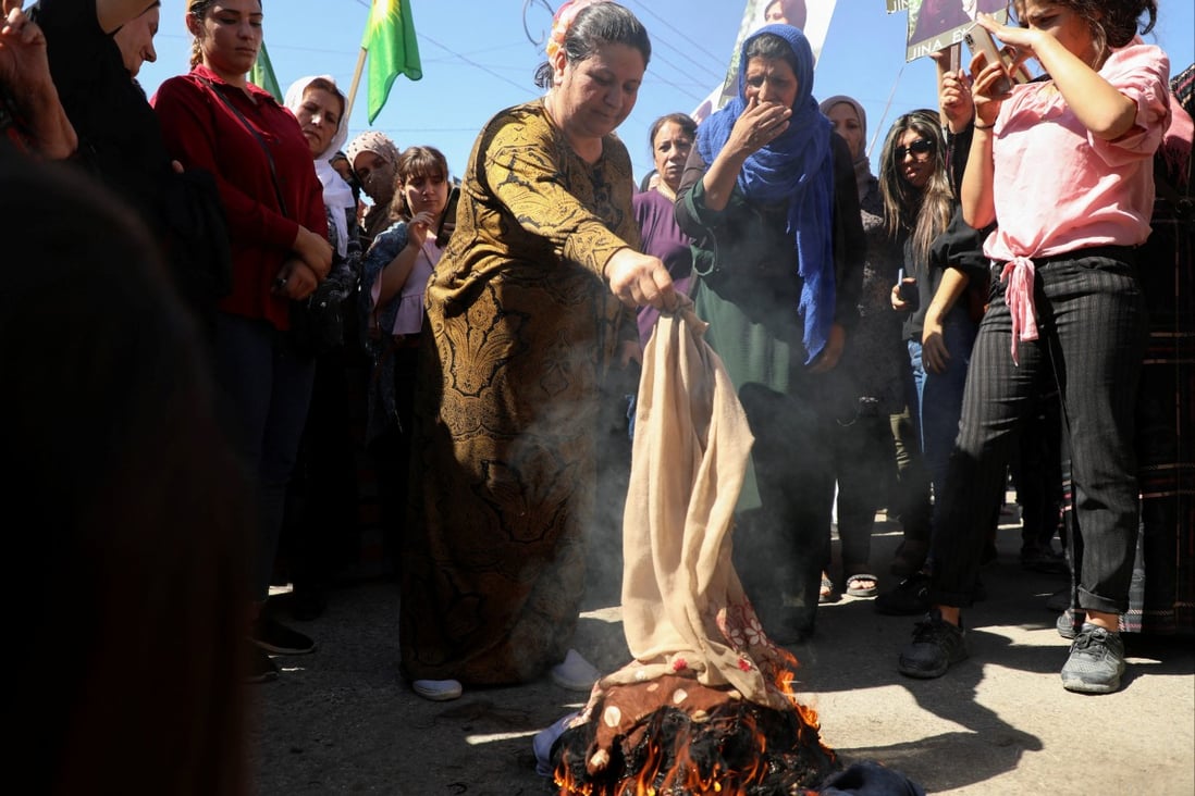 Women burn headscarves during a protest over the death of 22-year-old Kurdish woman Mahsa Amini in Iran, in the Kurdish-controlled city of Qamishli, Syria. Photo: Reuters