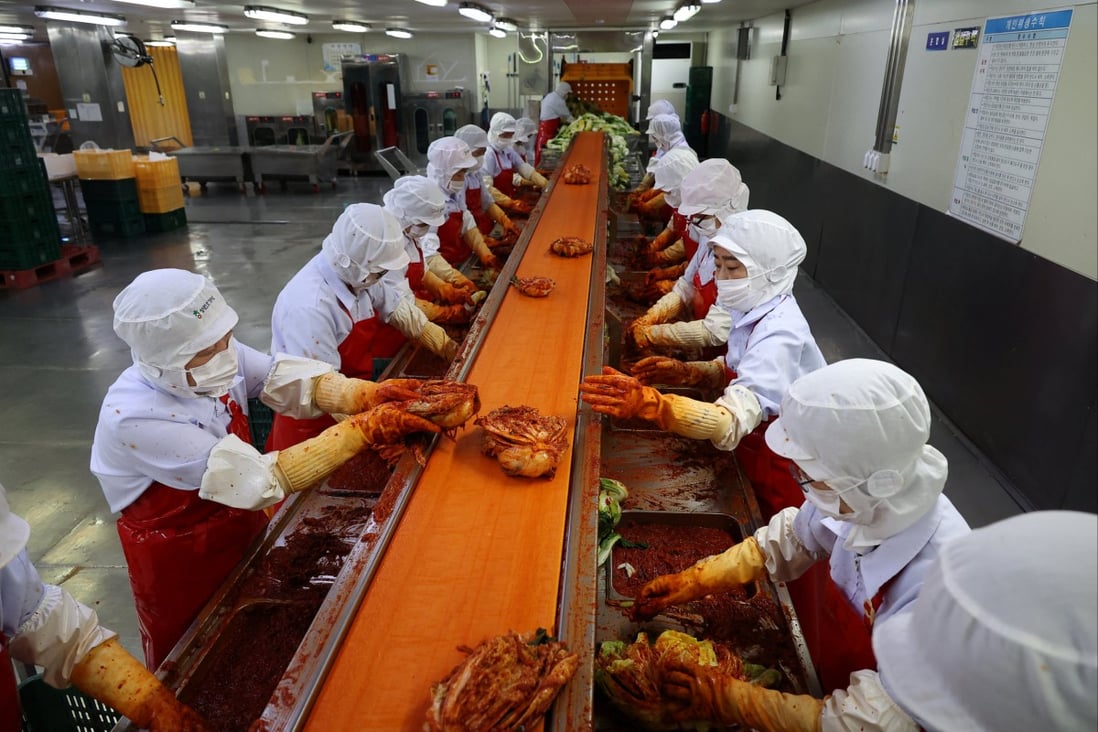 Employees work at Cheongone Organic kimchi factory in Cheongju, South Korea. Photo: Reuters