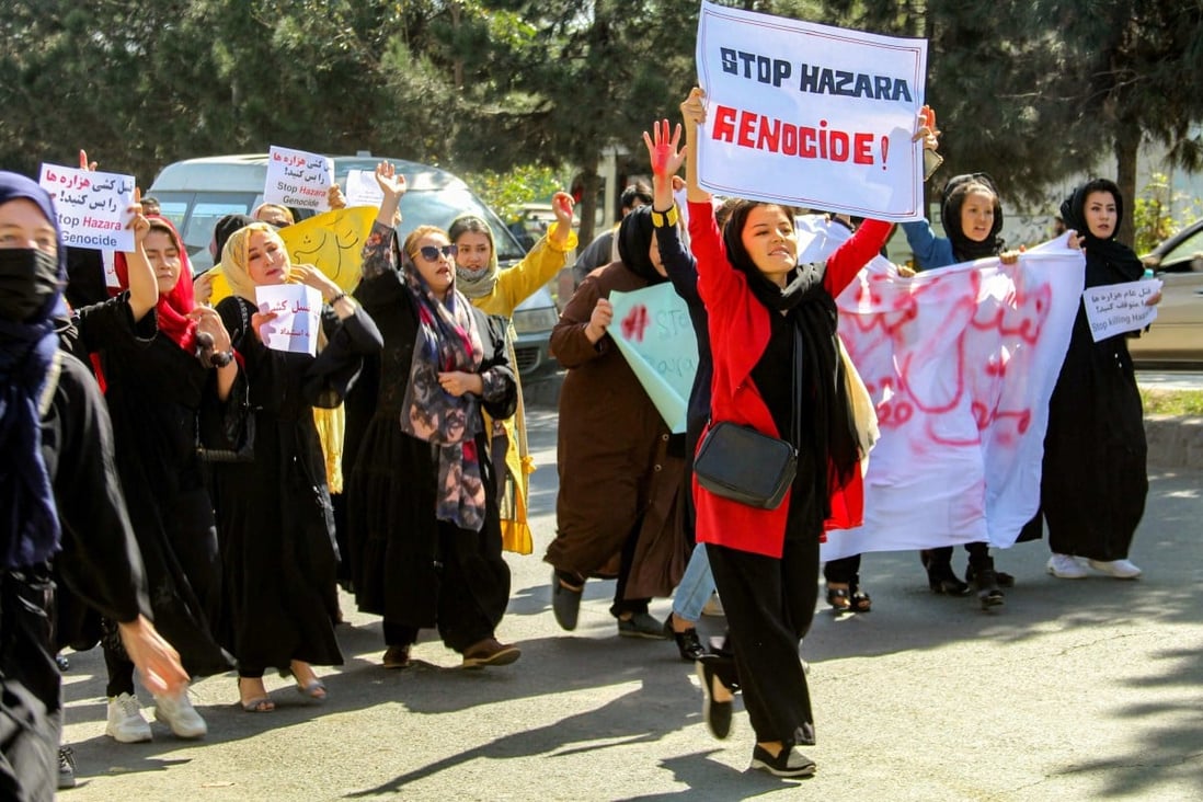Afghan women display placards and chant slogans during a protest they call “Stop Hazara genocide” a day after a suicide bomb attack at Dasht-e-Barchi learning centre, in Kabul on Saturday. Photo: AFP
