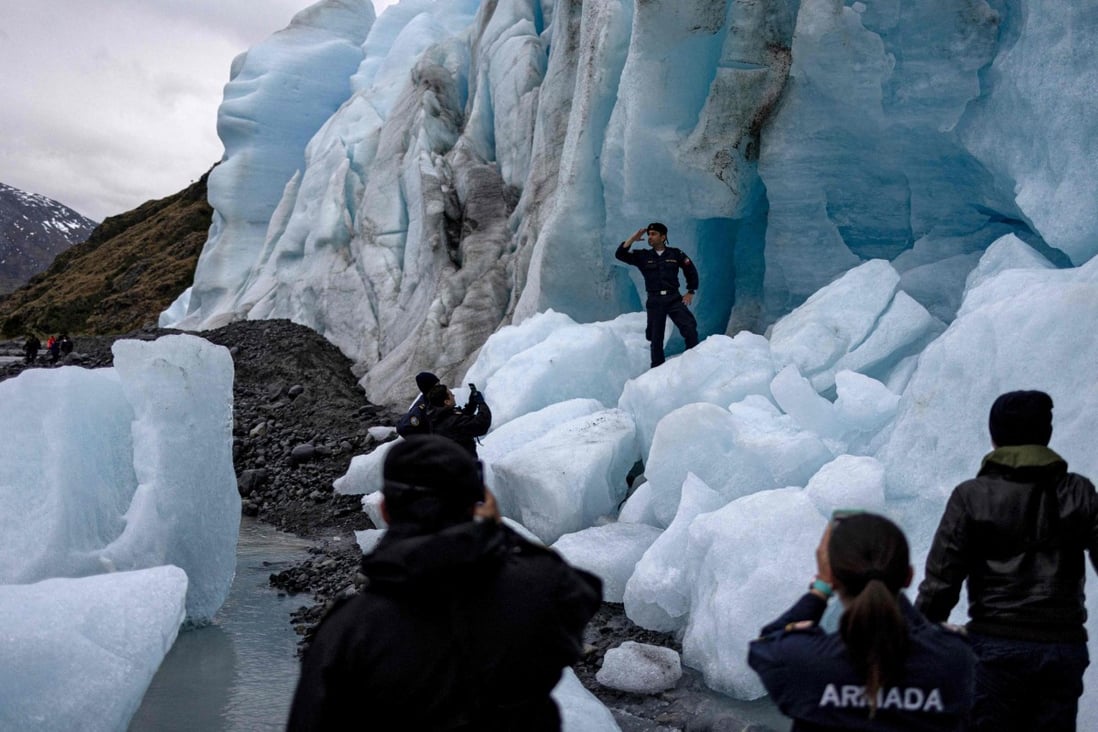 Researchers take photos at Fouque glacier in Chile on November 30, 2021. Photo: AFP